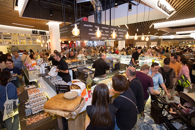 Customers enjoy the many food stalls in El Mercat, the indoor market located in the shopping centre Glories.